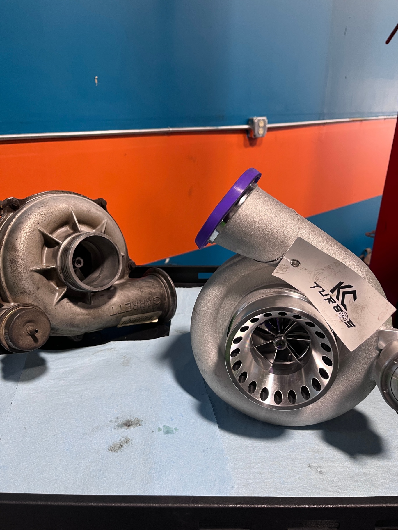 OEM turbocharger next to a new KC Turbos performance turbo